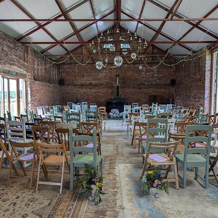 Will and Nick's wedding ceremony with rustic chairs